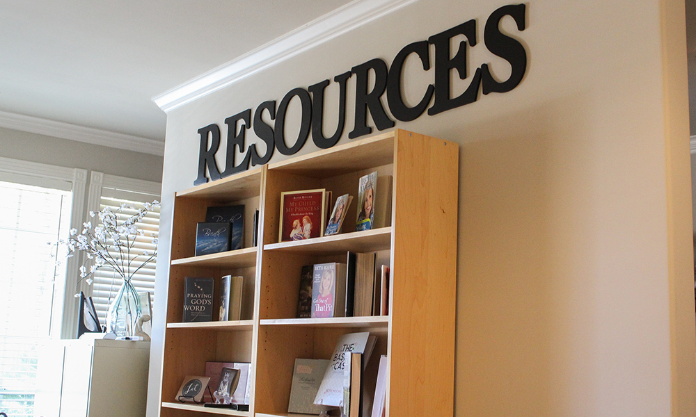 Image of the ministry reading room and store, with standing bookcases featuring minsgtry teaching books and materials.